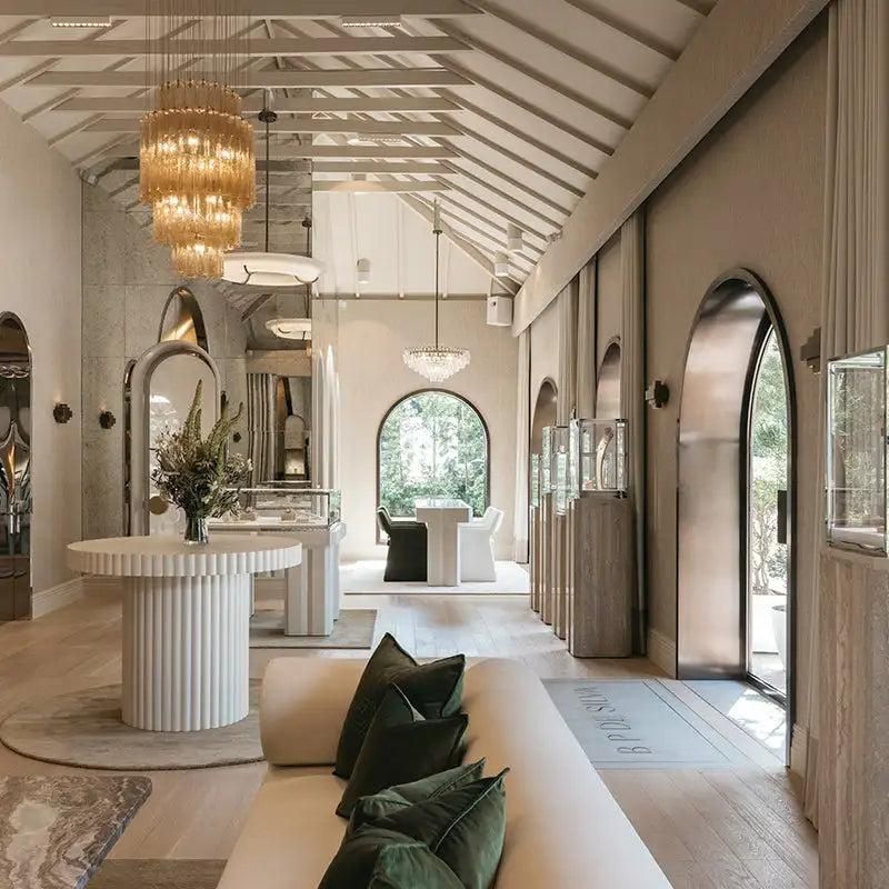 Mint & Moss showroom with arched windows, chandeliers and moss green cushions